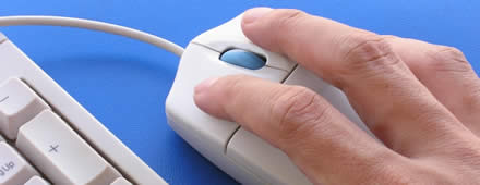 Picture of a hand on a computer mouse.